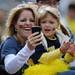Michigan fans Amy and Alyssa Bradt, of Belleville smile as Amy films the football team entering the tunnel during pregame against Eastern Michigan at Michigan Stadium on Saturday. Melanie Maxwell I AnnArbor.com